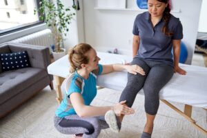 Physio attends to patient in a bright, modern office.