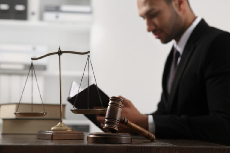 An experienced medical negligence solicitor reads a legal textbook at a desk