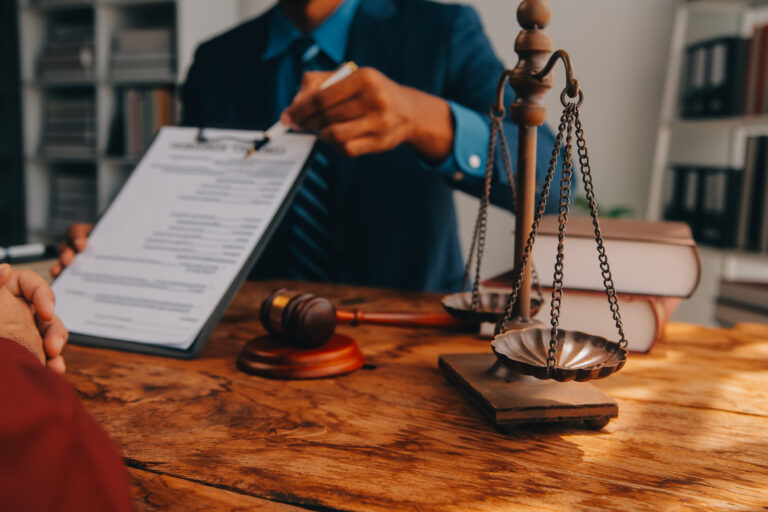 A solicitor shows a contract to their client for electric shock injury claims.