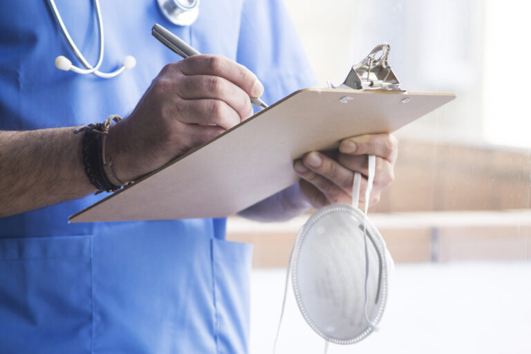 A doctor making medical notes of a patient who suffered from a pneumonia misdiagnosis
