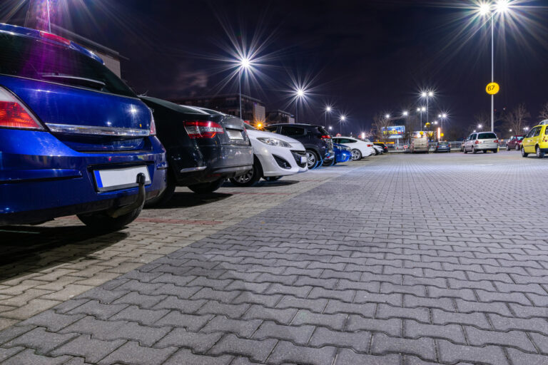 A group of cars lined up in a car park at night