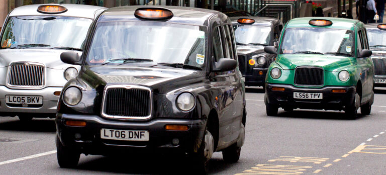 A black cab driver following safety laws to avoid road traffic collision and accidents involving other road users.