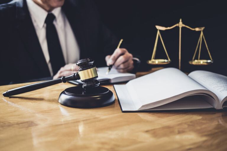 A solicitor works on beauty treatment claims while sat at a desk