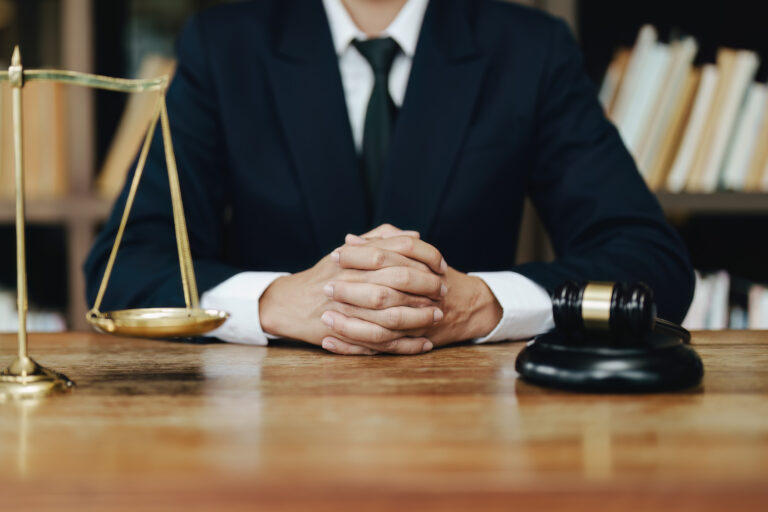 A solicitor sitting and explaining defective product compensation claims with justice background.