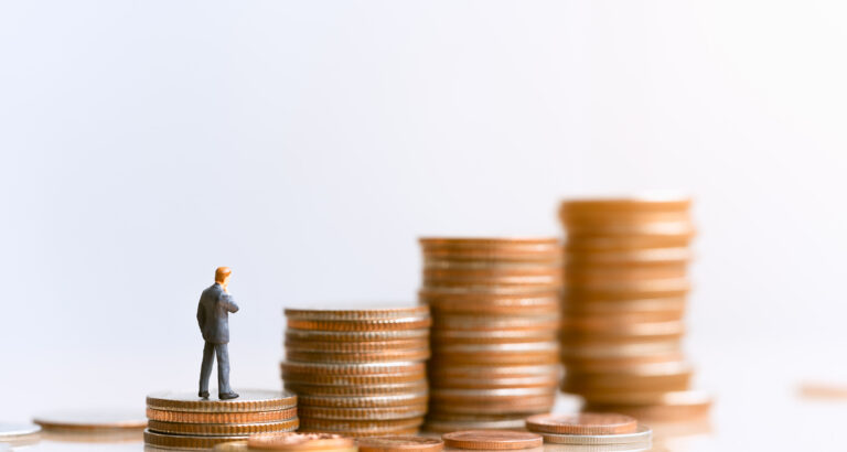 A graphic of a man in a suit on top of stacks of coins