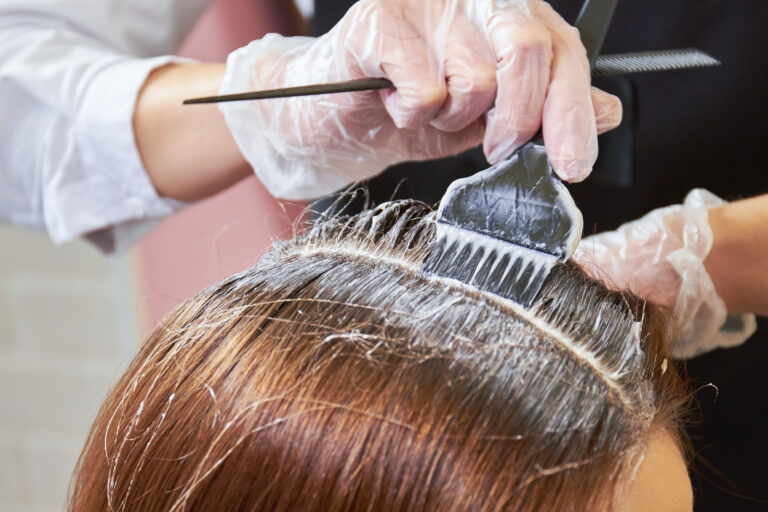 A woman is getting her hair bleached at a hair salon and the stylist damages her hair follicles resulting in the client making a hairdresser injury compensation claim.