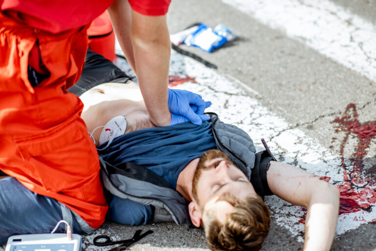 A pedestrian has been hit by a car at a zebra crossing.